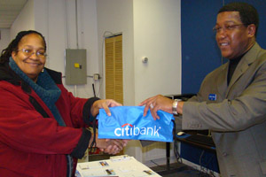 Sandy Ferguson, an Auburn Gresham resident, opens several accounts with Citibank's Herbert Johnson.