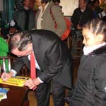 Mayor Daley autographs poster for  Auburn Gresham youth