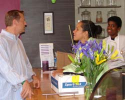 Fr. Pfleger shares words of appreciation with co-owners Julie Welborn and Denise Nicholes for Perfect Peace Cafe & Bakery coming to Auburn Gresham.