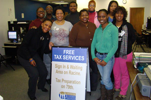 Pamela Wafford [L] and Rhonda Jones [R] poses with CEP volunteers at the St. Sabina ERC Resource Room